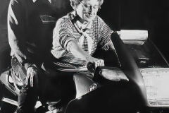 Nola seated on Patrick Horton’s BMW, with Patrick on the pillion. Patrick was past President of MCC. Image by Barrie Bunning